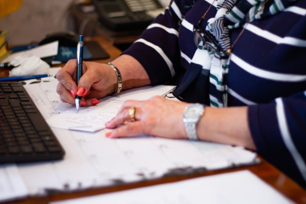 Senior reviewing financial documents at desk