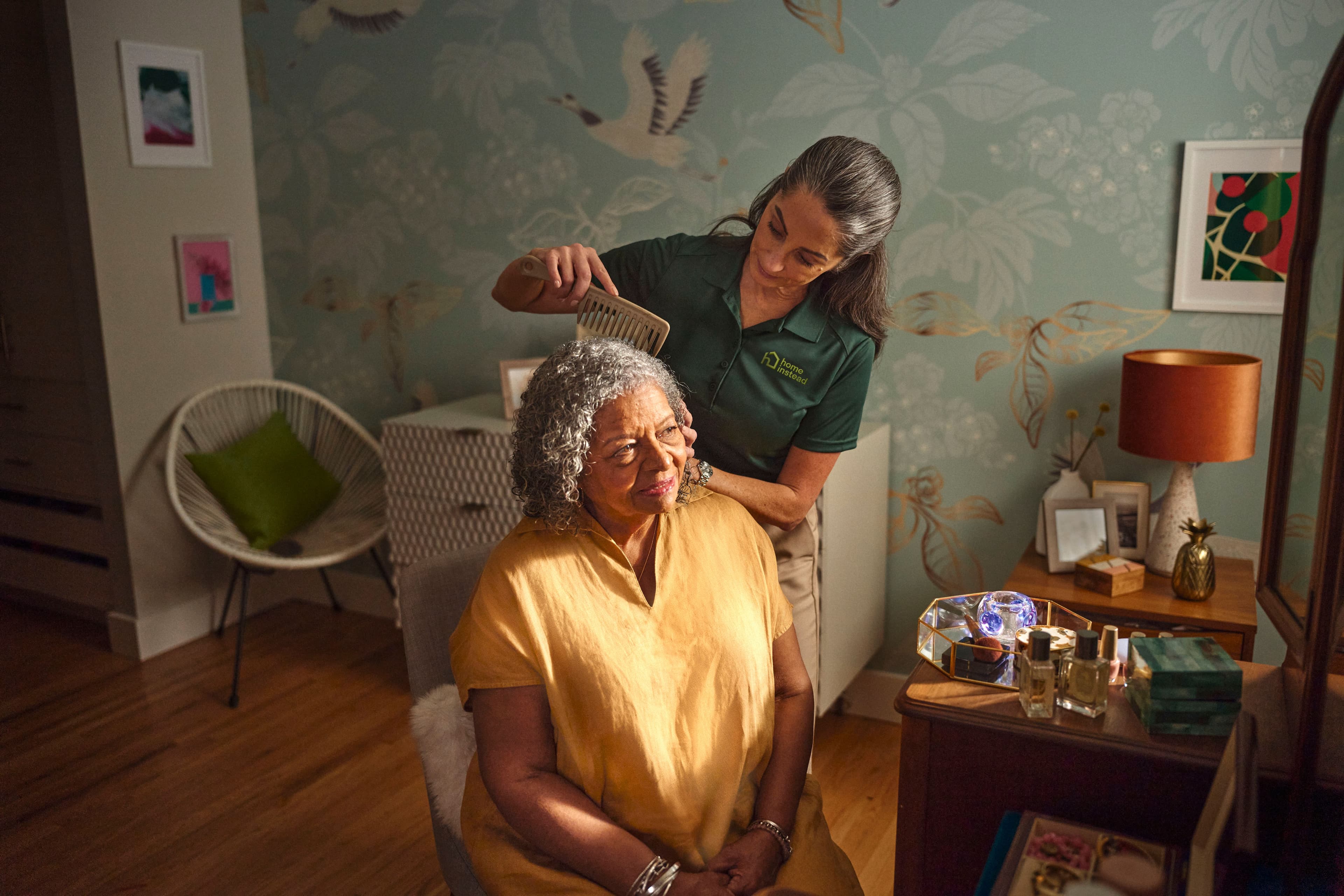 A Care Pro providing personal care to an aging adult.