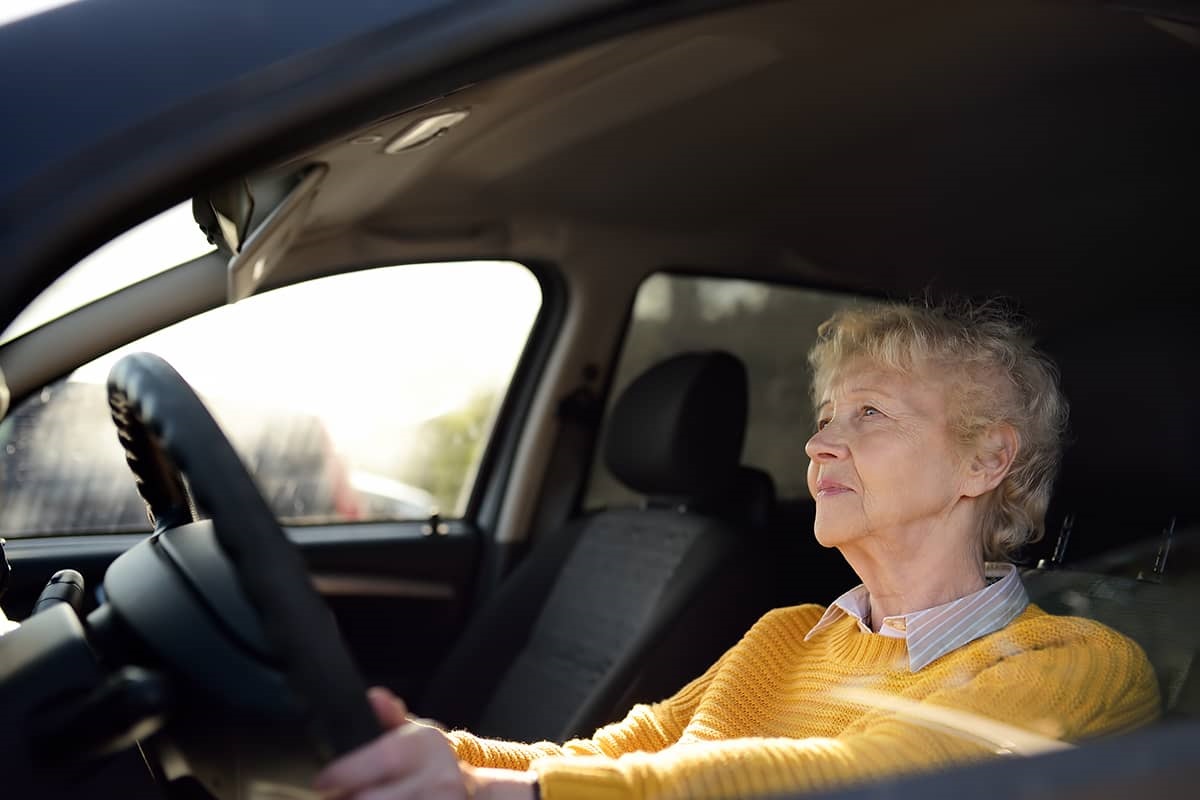 Older woman driving a car