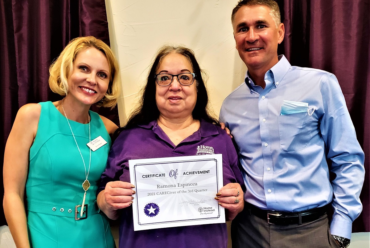 CAREGiver of the Quarter Ramona with franchise owners the Farbers