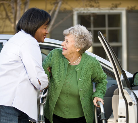 home instead caregiver helping bellaire senior out of the car