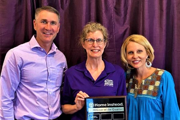 Caregiver of the Quarter Dora with Franchise Owners