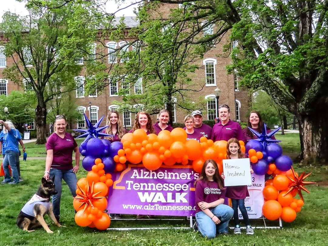 Photo of our Home Instead Team in front of the 2023 Foothills Alzheimer's Tennessee Walk sign
