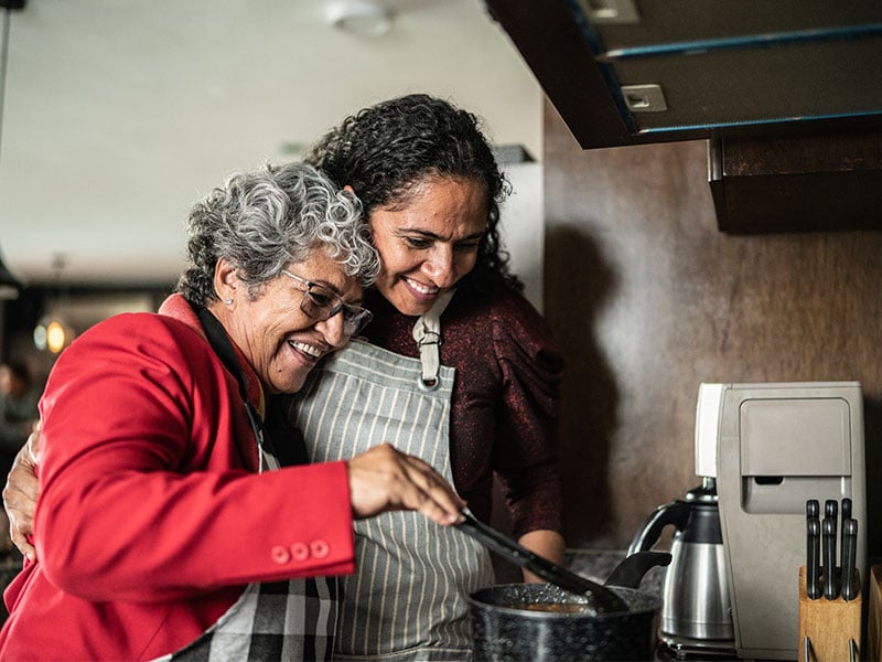 respite care 800x600px happy caregiver and senior lady cooking