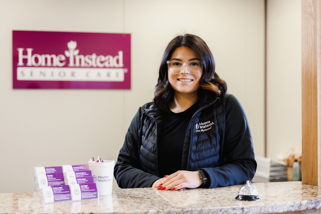 Home Instead Team Member Stand Behind the Front Counter