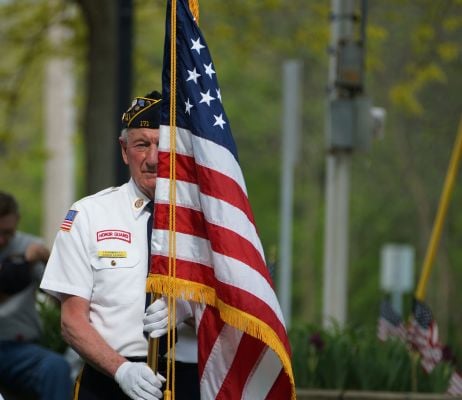honor guard veteran holding a flag