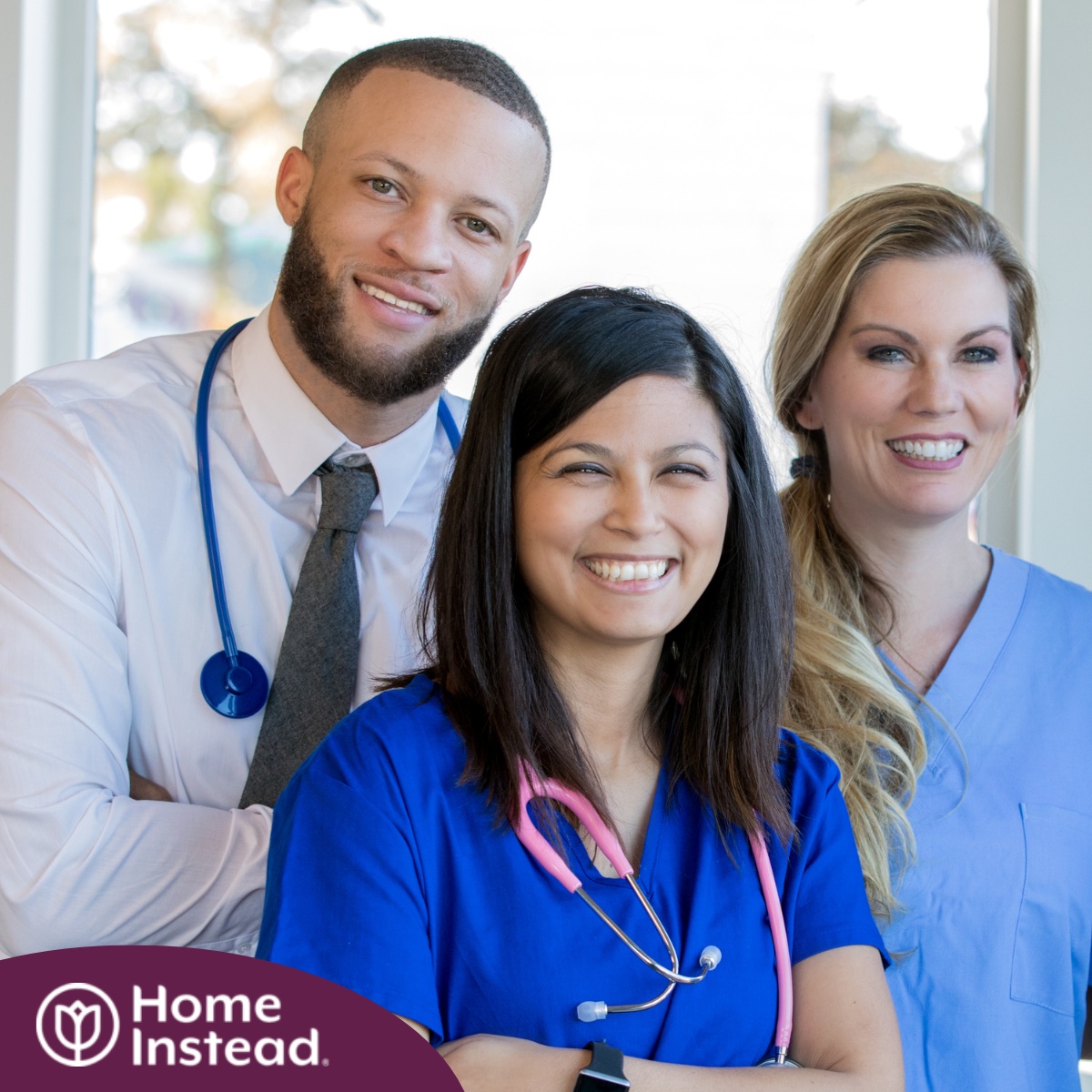 A team of healthcare professional smiles, representing the many career paths that professional caregiving can lead to.