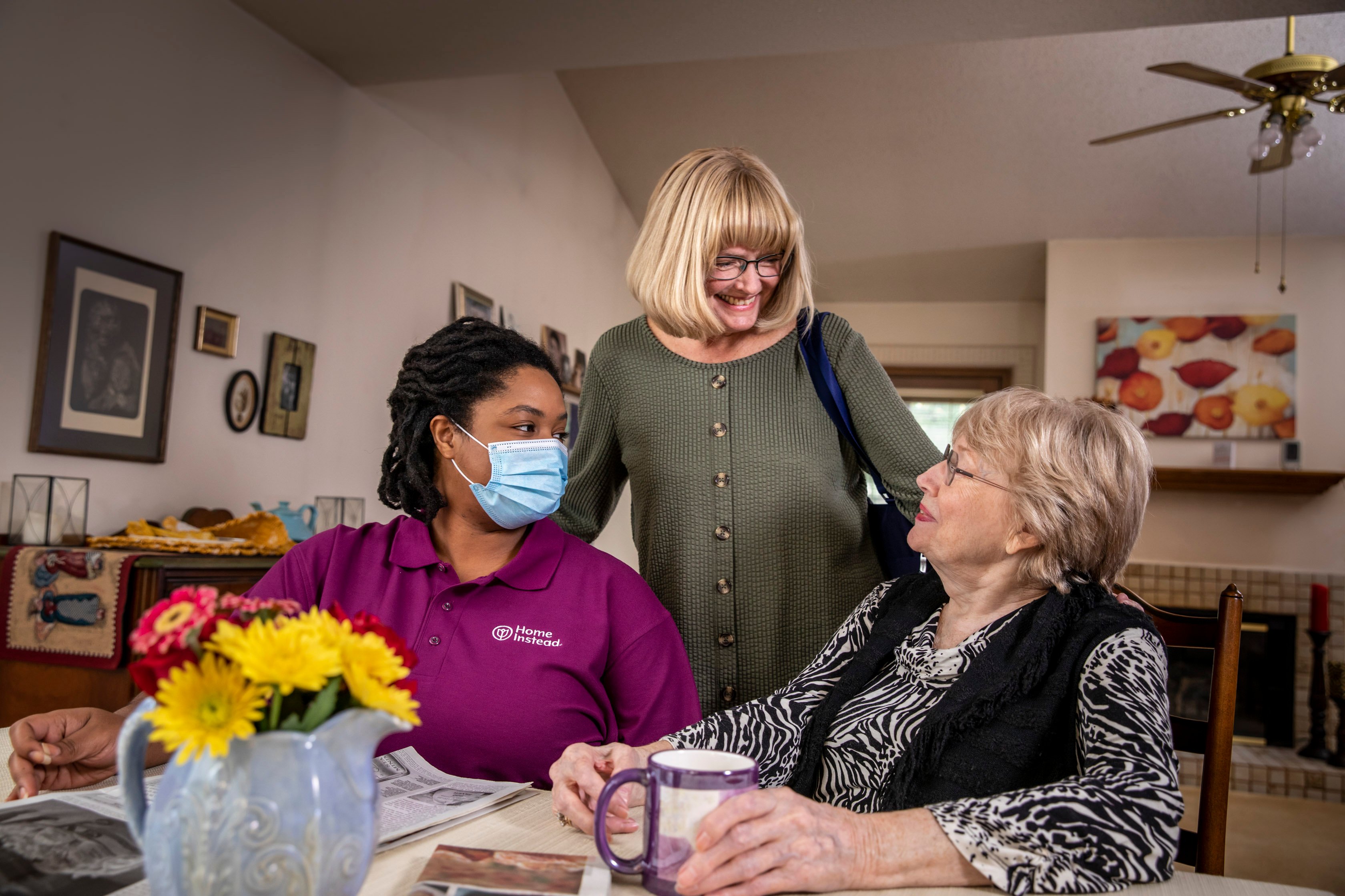 Caregiver with Client and Family Member
