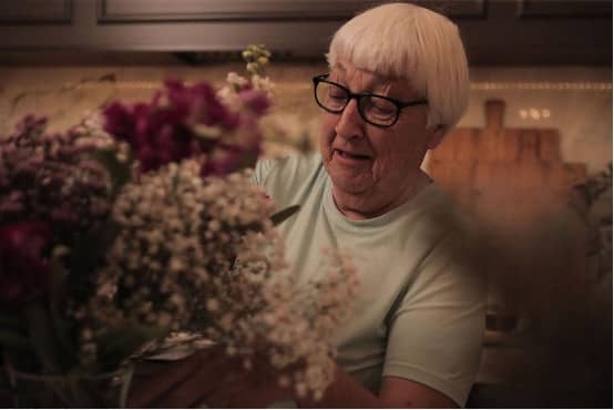 Senior looking at flowers in the kitchen (1).jpg