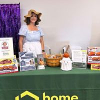 home instead team member at well o ween booth