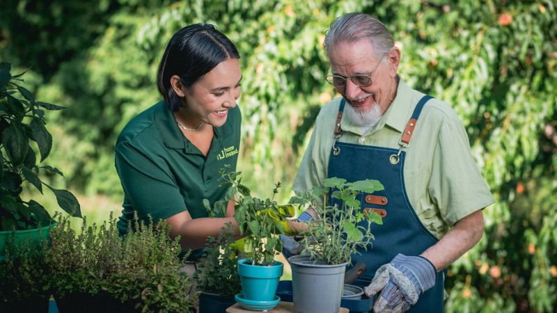 home instead caregiver gardening with senior client