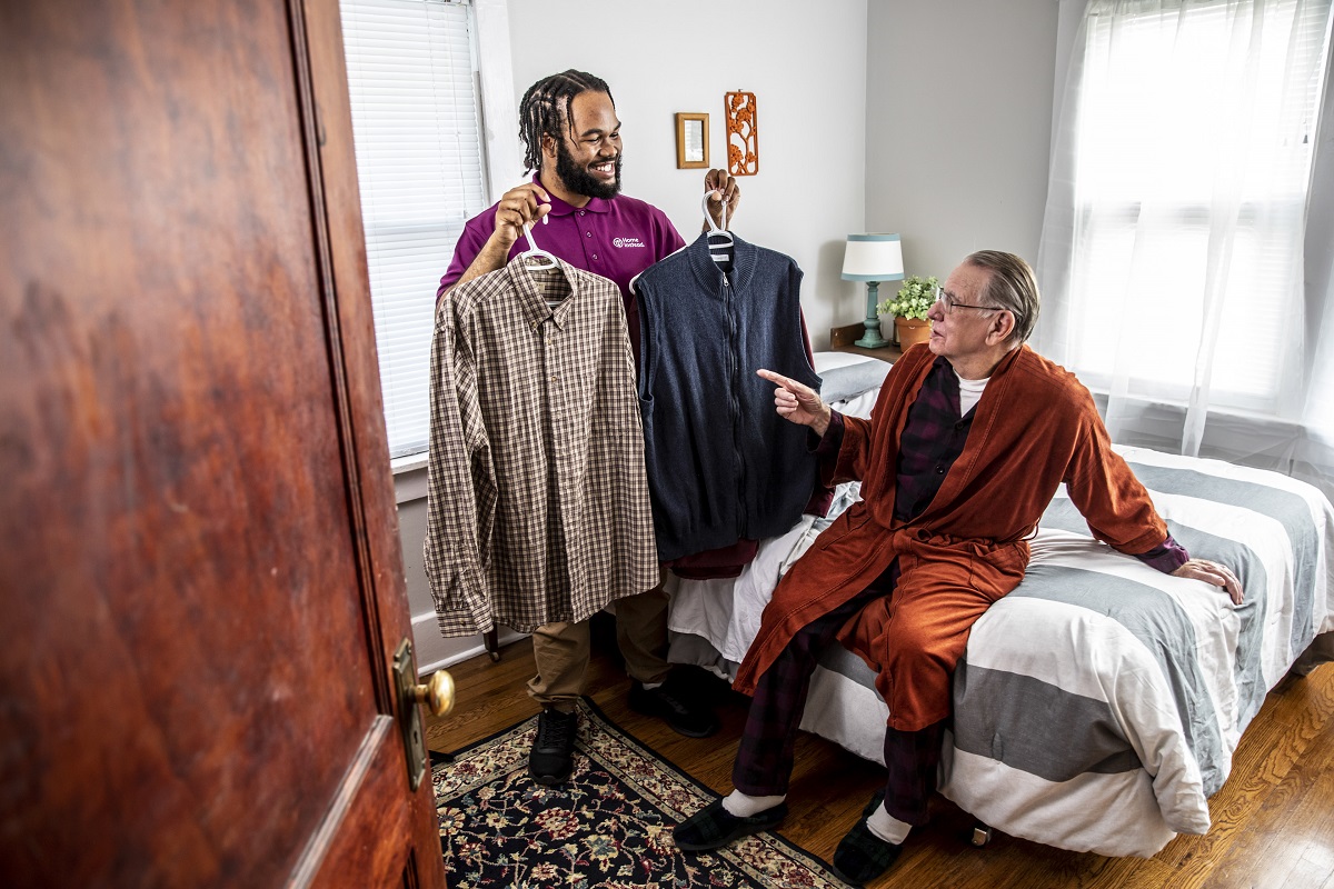 Home Instead Caregiver assisting male client with clothing choice
