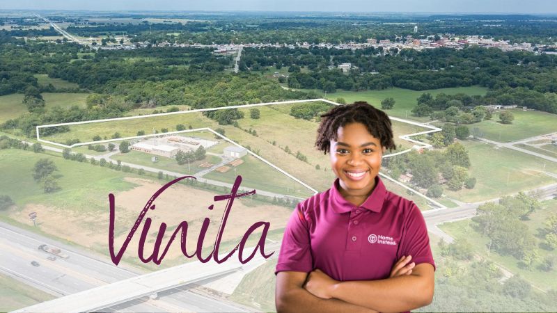 Home Instead caregiver with Vinita Oklahoma in the background