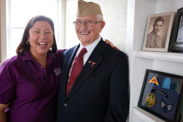 home instead caregiver with smiling male veteran
