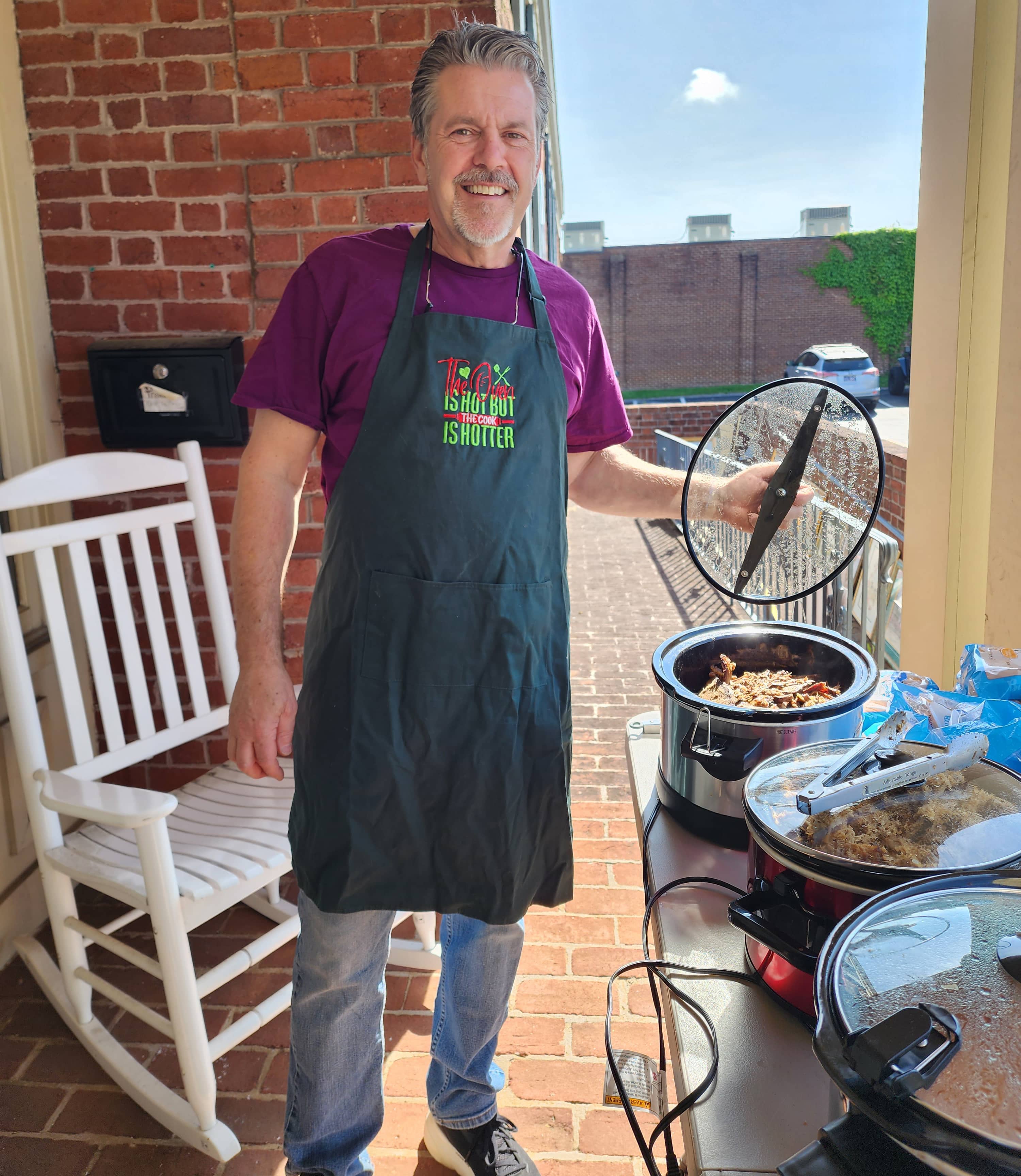 Photo of Home Instead Owner Matt Noll cooking some BBQ for the Trash to Treasure Sale and BBQ Fundraiser for Alzheimer’s TN
