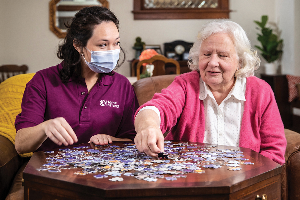 two women working on a puzzle