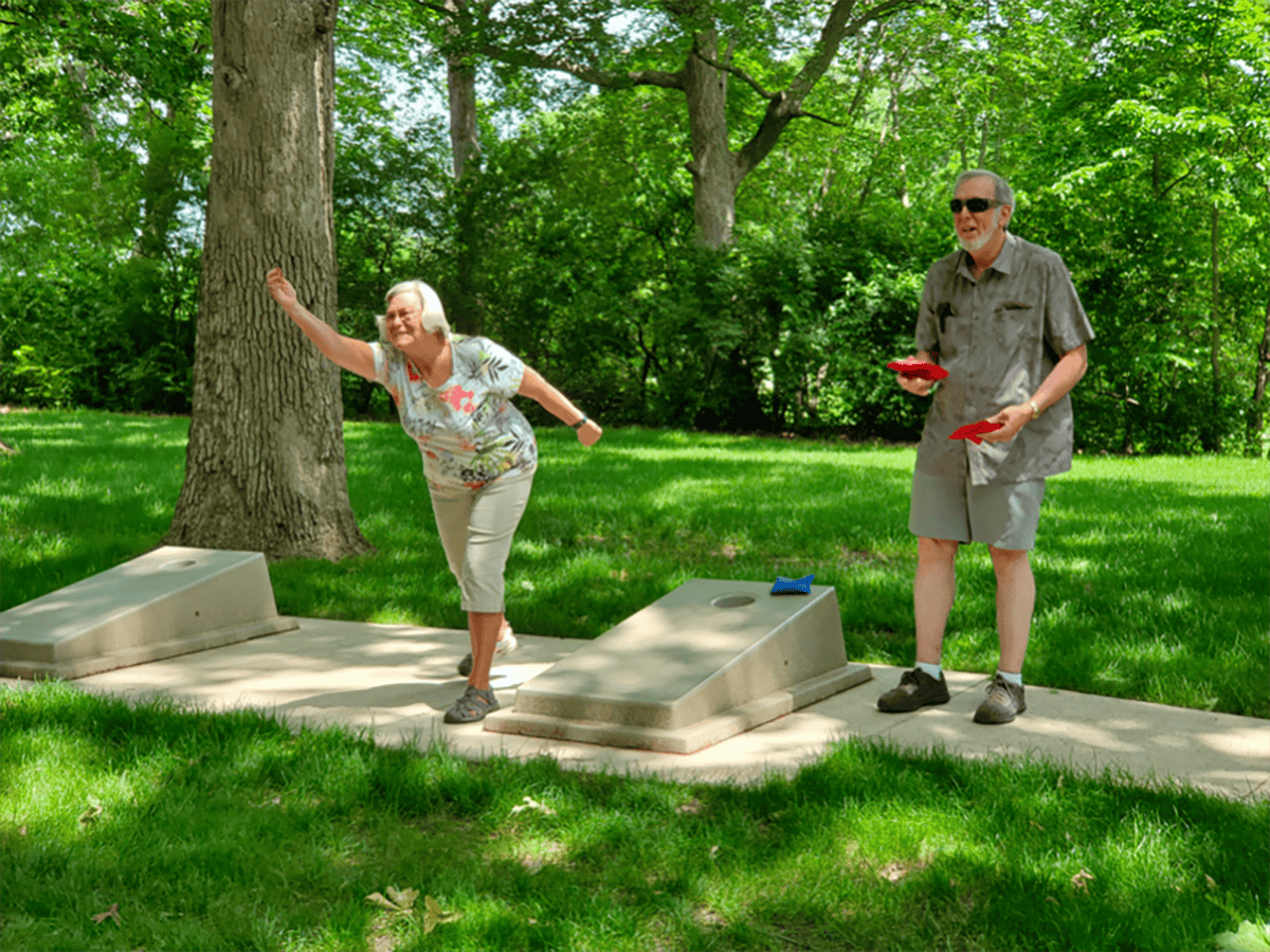 2 Seniors playing cornhole