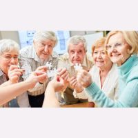 group of smiling seniors holding puzzle pieces