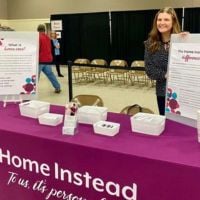 home instead team member at booth at memorial health care systems health fair