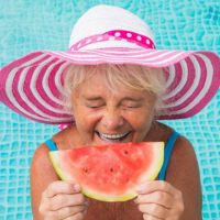 senior lady enjoying a slice of watermelon