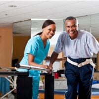 caregiver with senior doing physical therapy