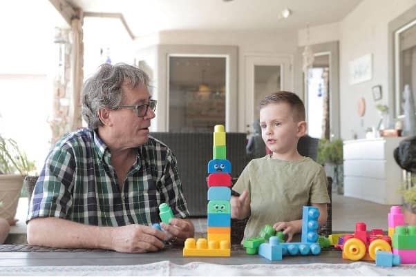 Senior and child playing blocks in a sunroom (1).jpg