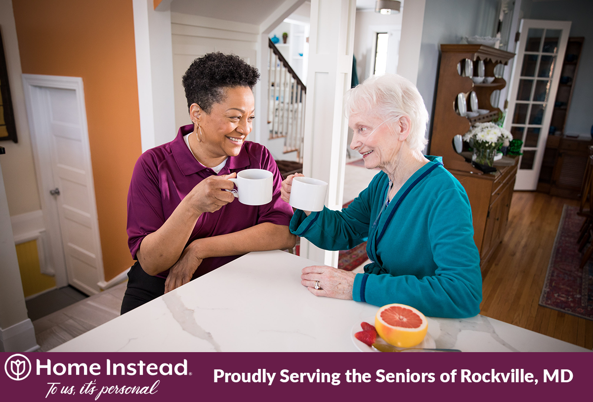 Elderly woman enjoying coffee with her caregiver