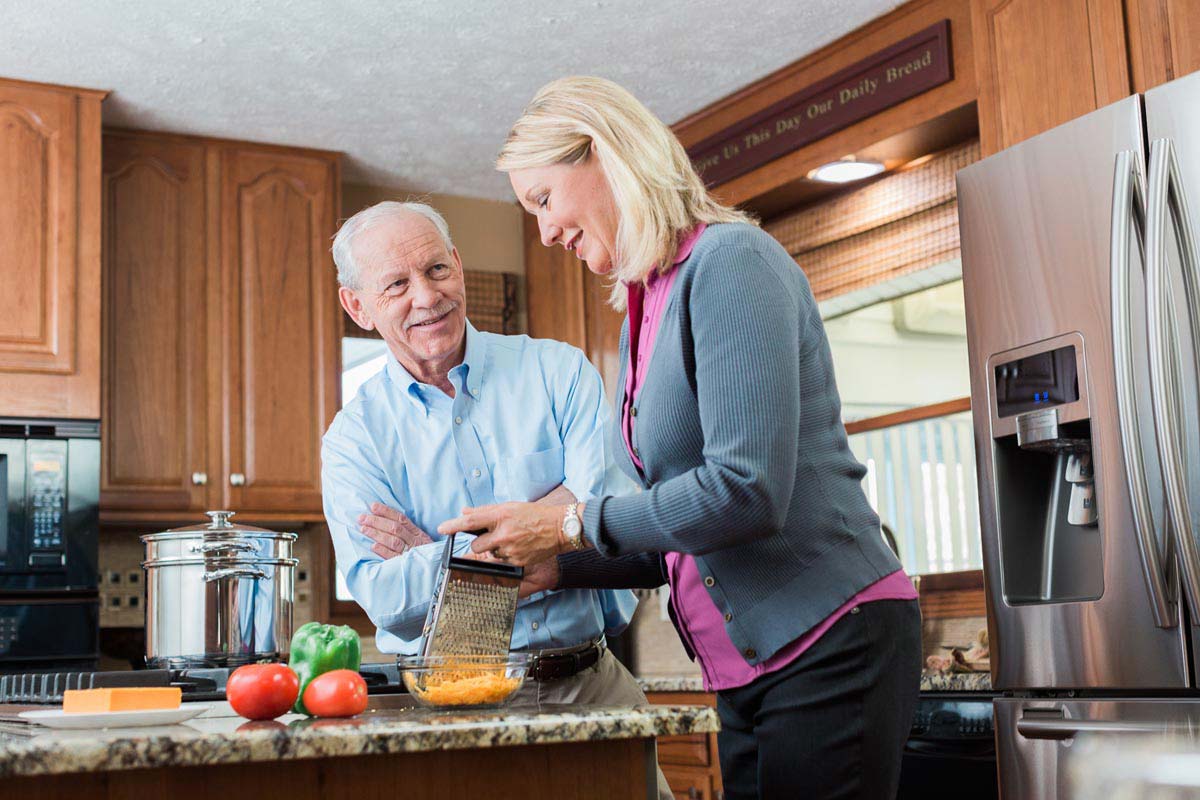 Caregiver and Senior preparing meals