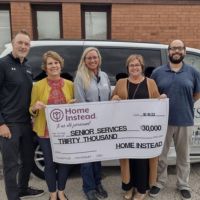 Home Instead Donates check to Senior Services