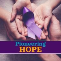 sets of hands holding purple alz ribbon