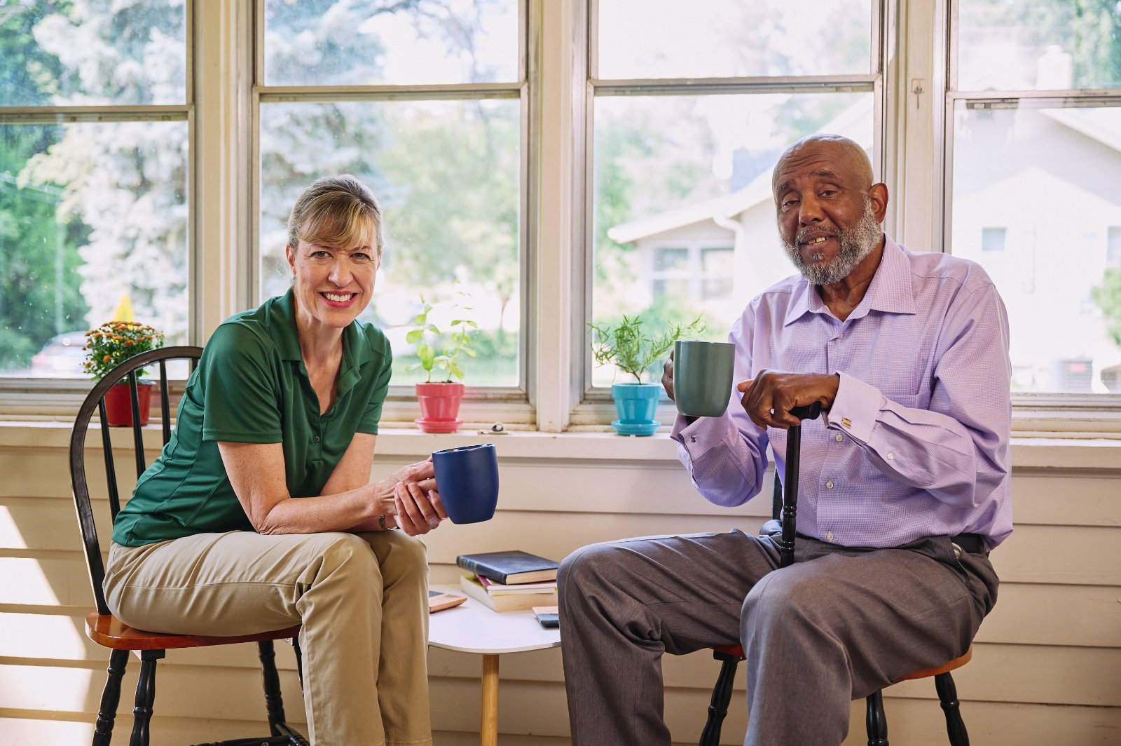 Home Instead Caregiver wearing mask brings groceries to the home of an aging adult.