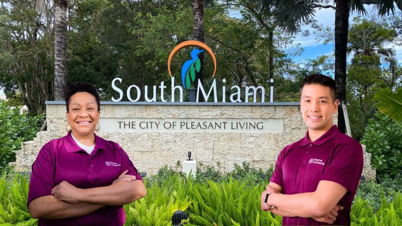 Home Instead caregivers with South Miami, FL in the background