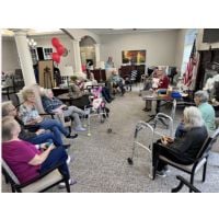 home instead team having senior trivia day with addington place community seniors