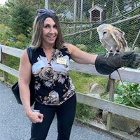 home instead employee holding owl at stoneham zoo
