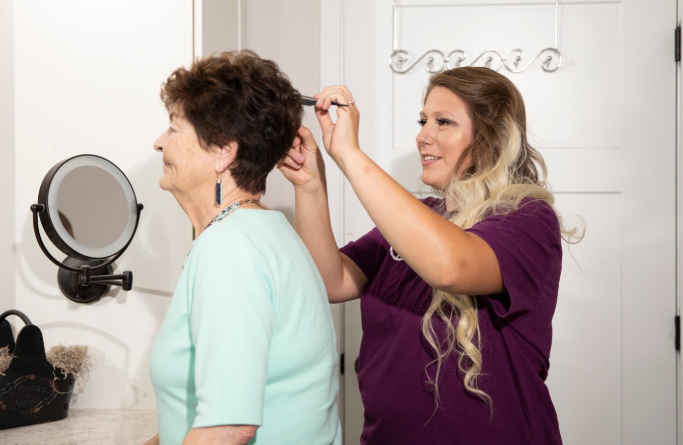 Caregiver brushing her clients hair