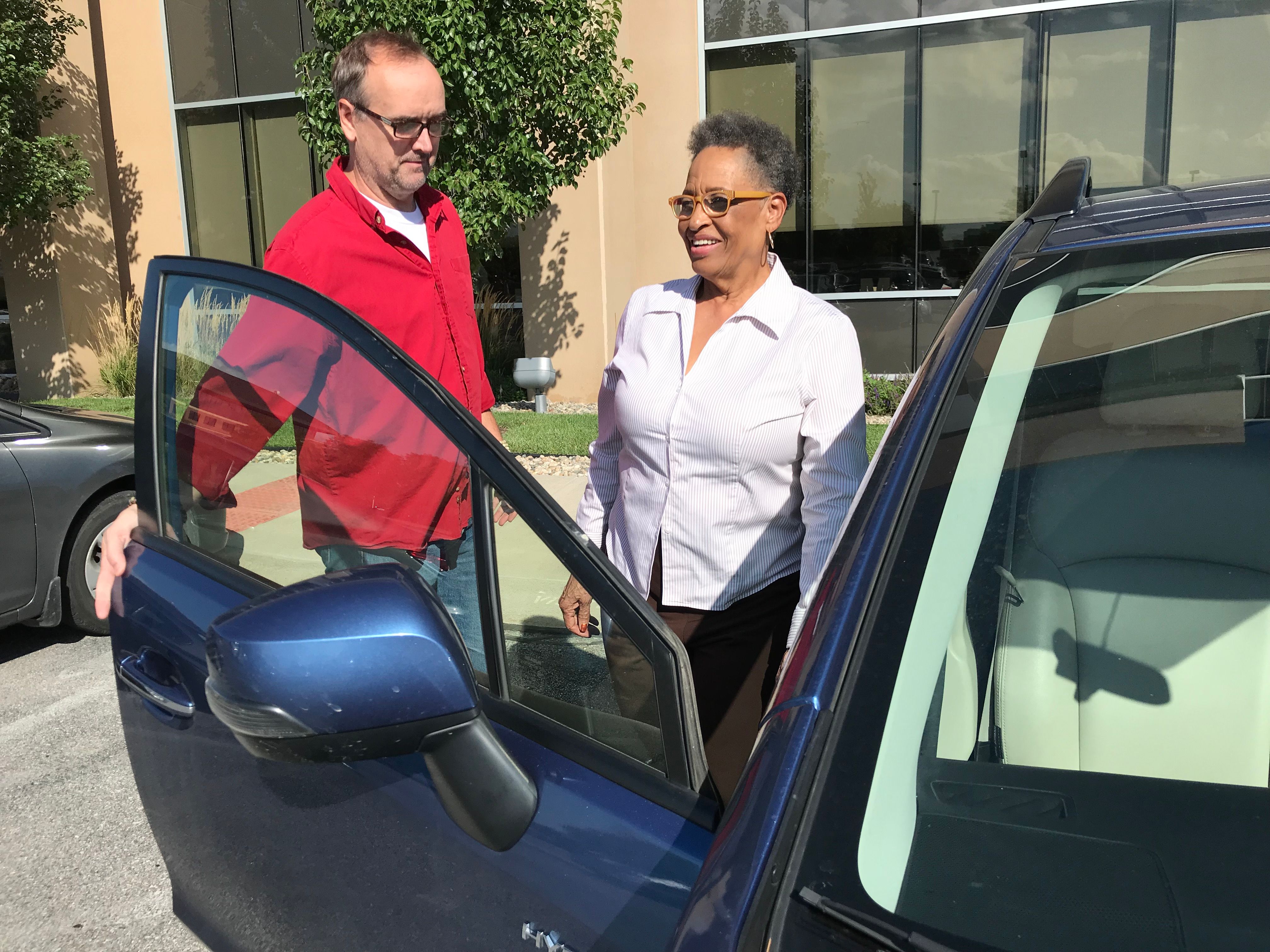 man opens car door for woman