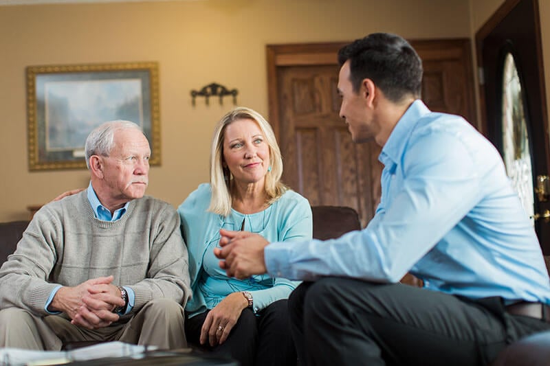 Home Care Consultant talking with an elderly man and his daughter about Home Care options