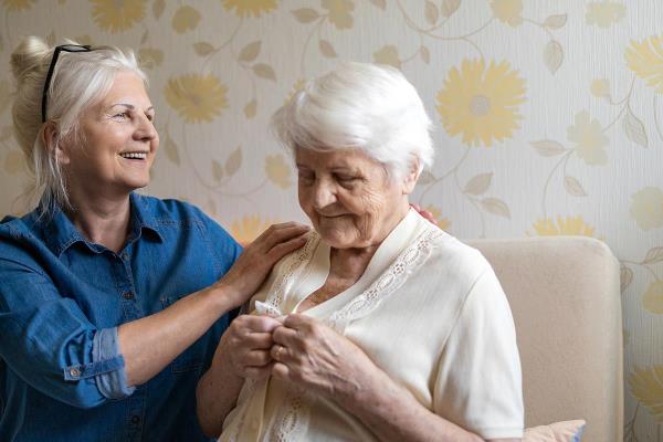 bigstock caregiver helping senior woman dre 371060062