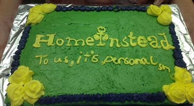 a cake decorated with the home instead logo and tagline