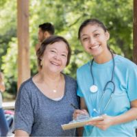 two smiling ladies at health fair in tecumseh, ne