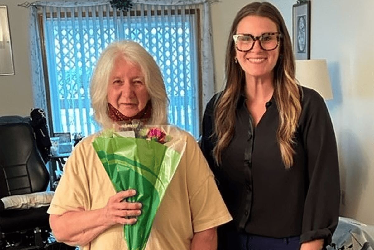 Photo of Our May 2023 CPOTM Rebecca being presented flowers by our Onboarding Assistant, Malorie