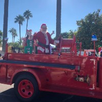 santa claus on a fire truck in a parade