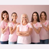 smiling ladies wearing pink breast cancer awareness shirts