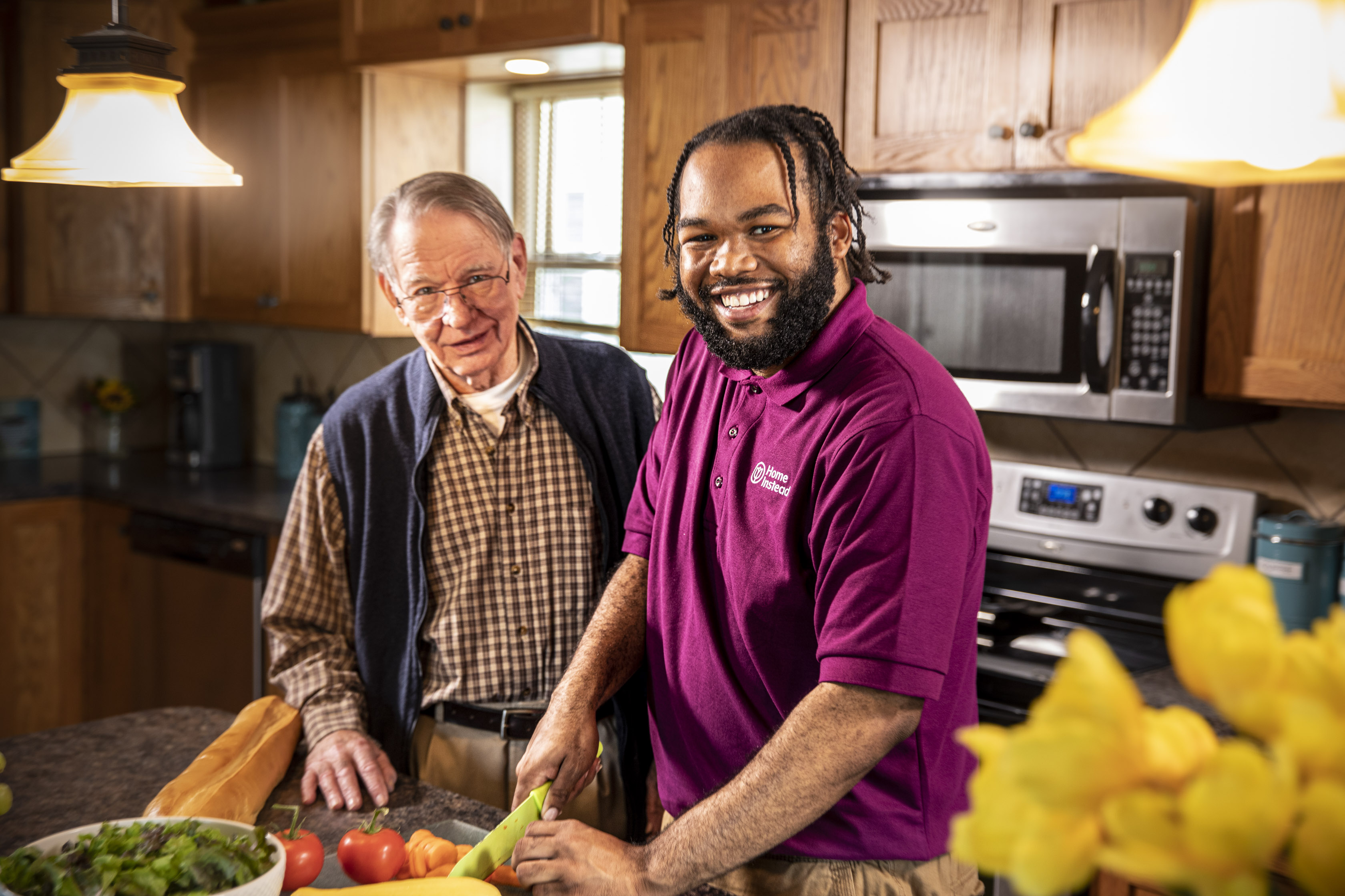 Home Instead Caregiver and Client cooking in the kitchen