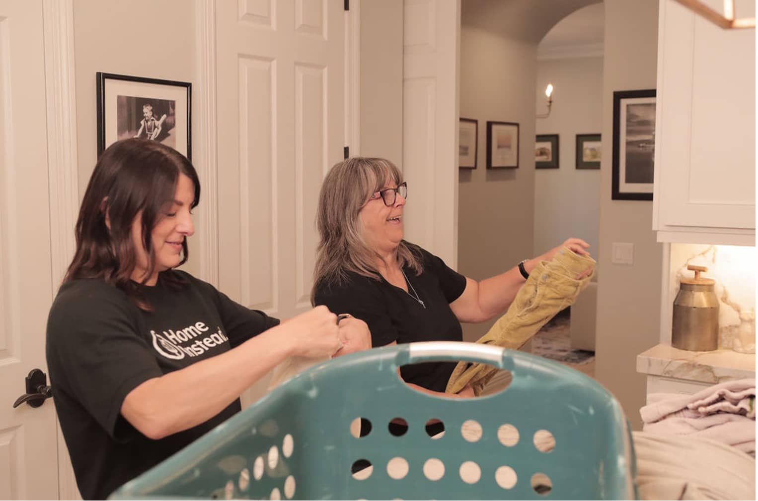 Photo of a caregiver and a senior folding laundry.jpg