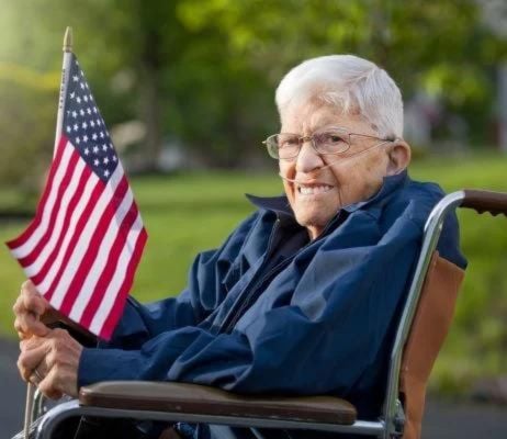 veteran in wheelchair holding USA flag