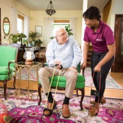 Home Instead Caregiver assisting senior client transitioning to home care