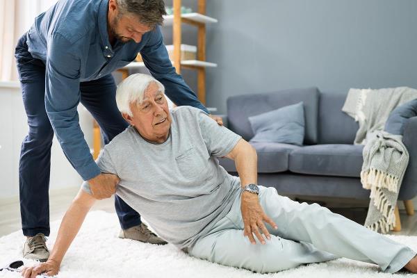 bigstock Helping Elder Senior Fallen Ma 381742700