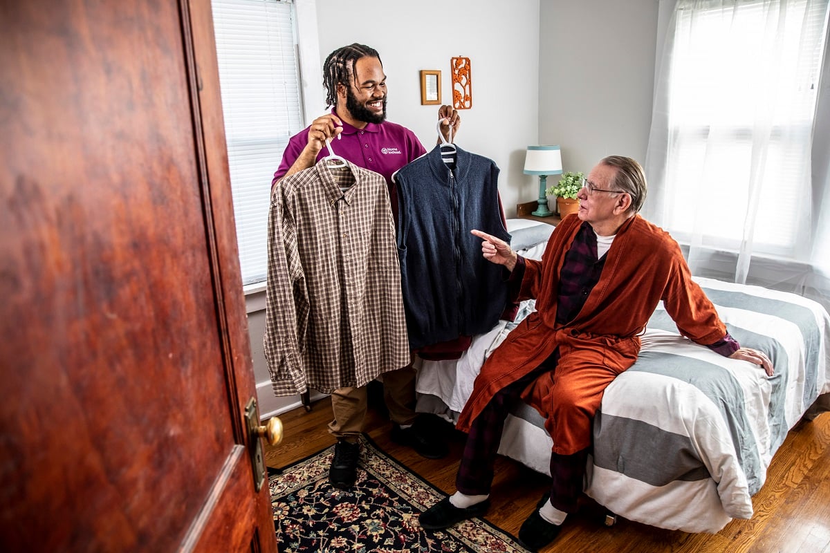 Home Instead Caregiver assisting male client with clothing choice