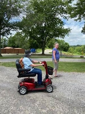 senior woman on a mobility scooter with her Care Professional recovering with Post-Surgical Care